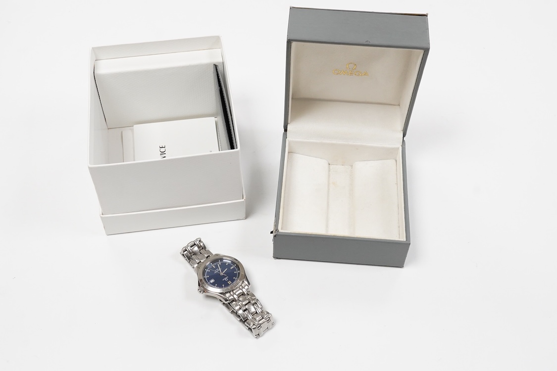 A gentleman's 1990's stainless steel Omega Seamaster quartz wrist watch, with blue dial dot markers and date aperture, case diameter 36mm, on a stainless steel Omega bracelet, with box and papers.